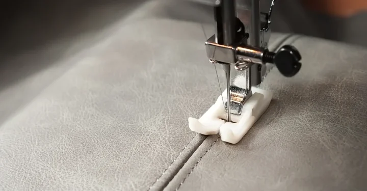 Sewing maching stitching leather.